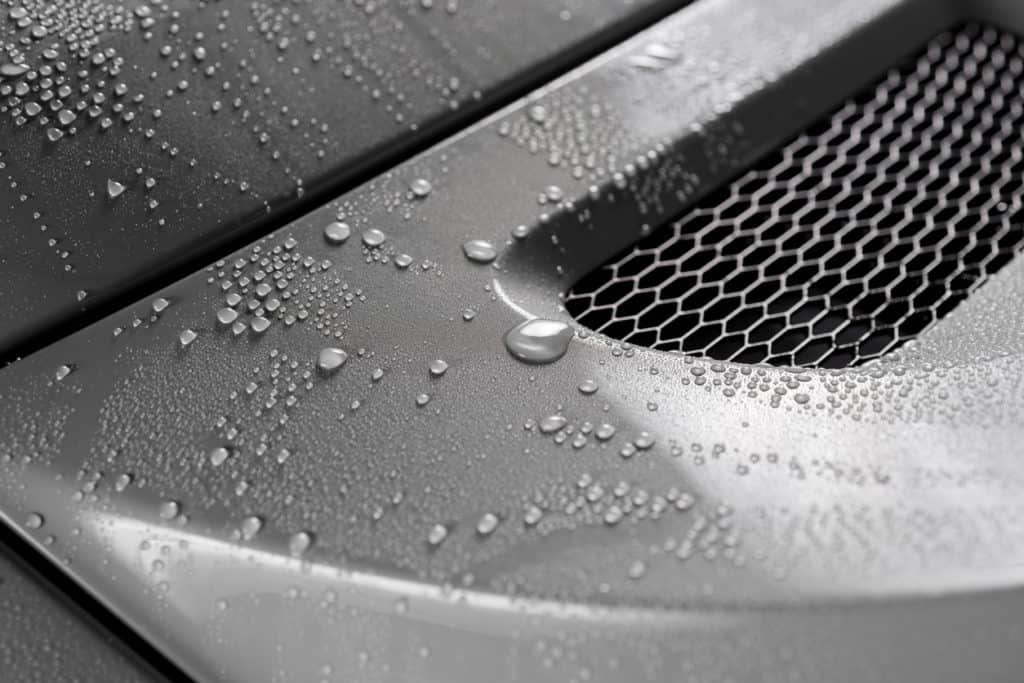 Water droplets on grey car with ceramic paint protection